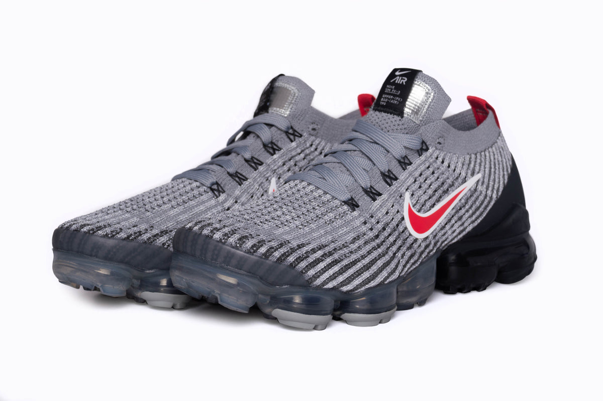 A frontal view of the Nike Air VaporMax Flyknit 3s. This angle showcases the signature Air Pods along the sole.