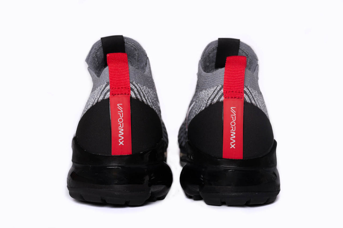 This angle showcases the Nike Air Vapormax Flyknit 3s from the back. Here you can find the signature VaporMax branding in a bright red colourway.